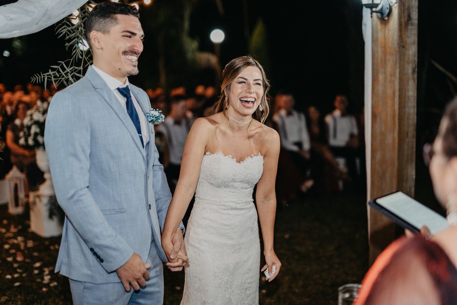 Bride and groom laughing joyfully during their wedding reception